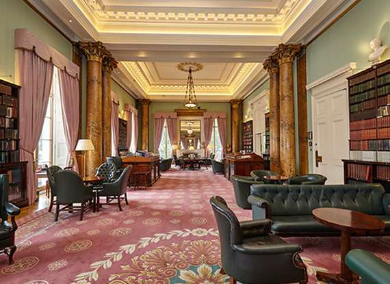 Inside the Athenaeum Club, salmon carpets and dark green leather chairs