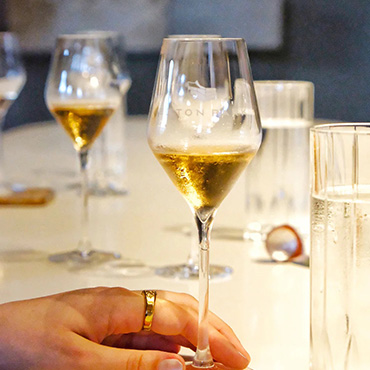 Lady holding glass of white wine